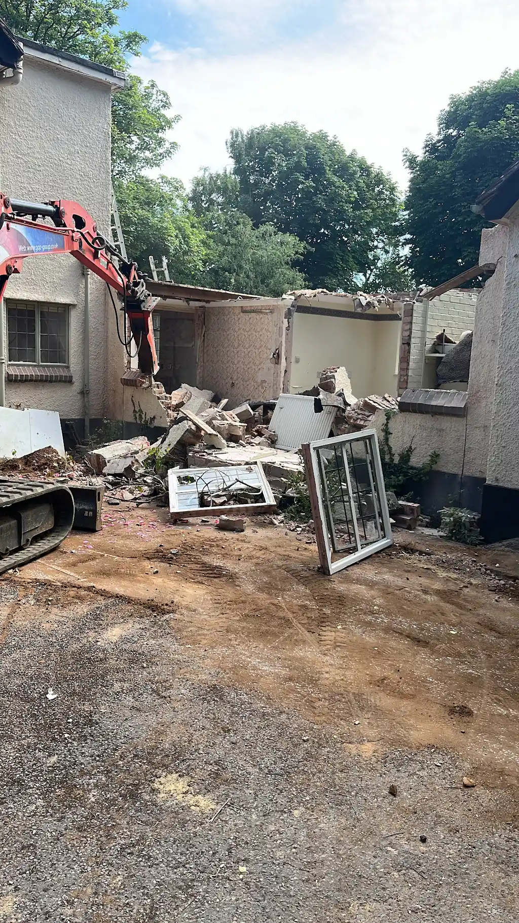 Site cleared after demolition with rubble pile and exposed party wall