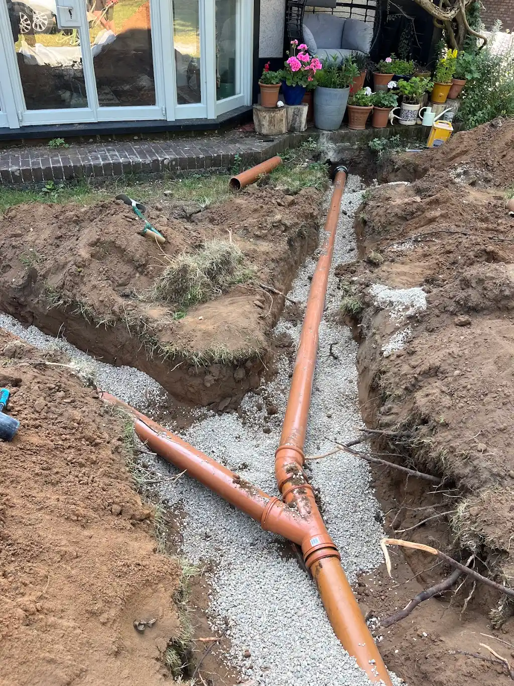 Long drainage trench with 110mm pipe running back to the cottage
