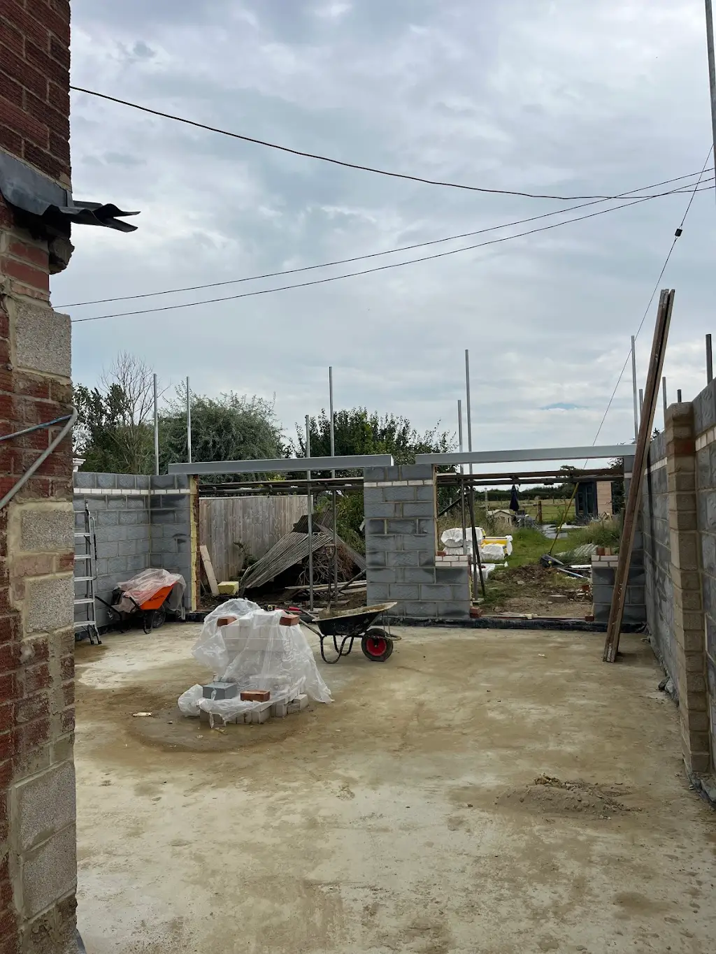 Structural steel beam installed across the rear opening